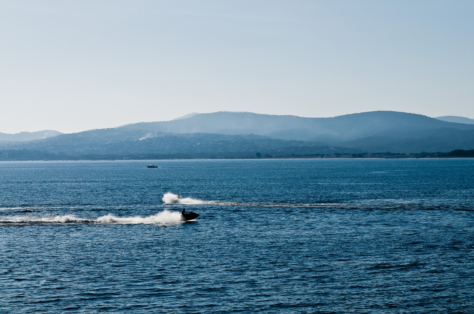 Jet-skis évoluant en rade de Saint-Tropez. A l'horizon, le massif des Maures.