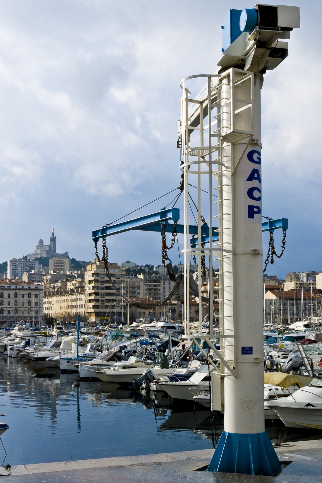 Marseille, Vieux-Port. Vue de Notre-Dame de la Garde, la Bonne Mère, derrière une grue de levage de bateau.